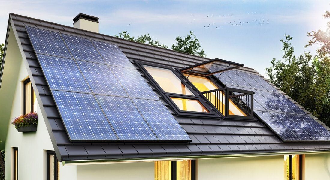 Aerial view of modern house with pool and solar panels, showcasing clean energy solutions by top solar power installers