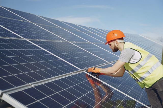 Worker installing solar panel, showcasing solar power on roof, solar energy cost, and best solar energy solutions.